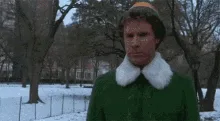 A sequence of six frames from the movie 'Elf' showing the character Buddy (played by Will Ferrell) in a green elf costume…