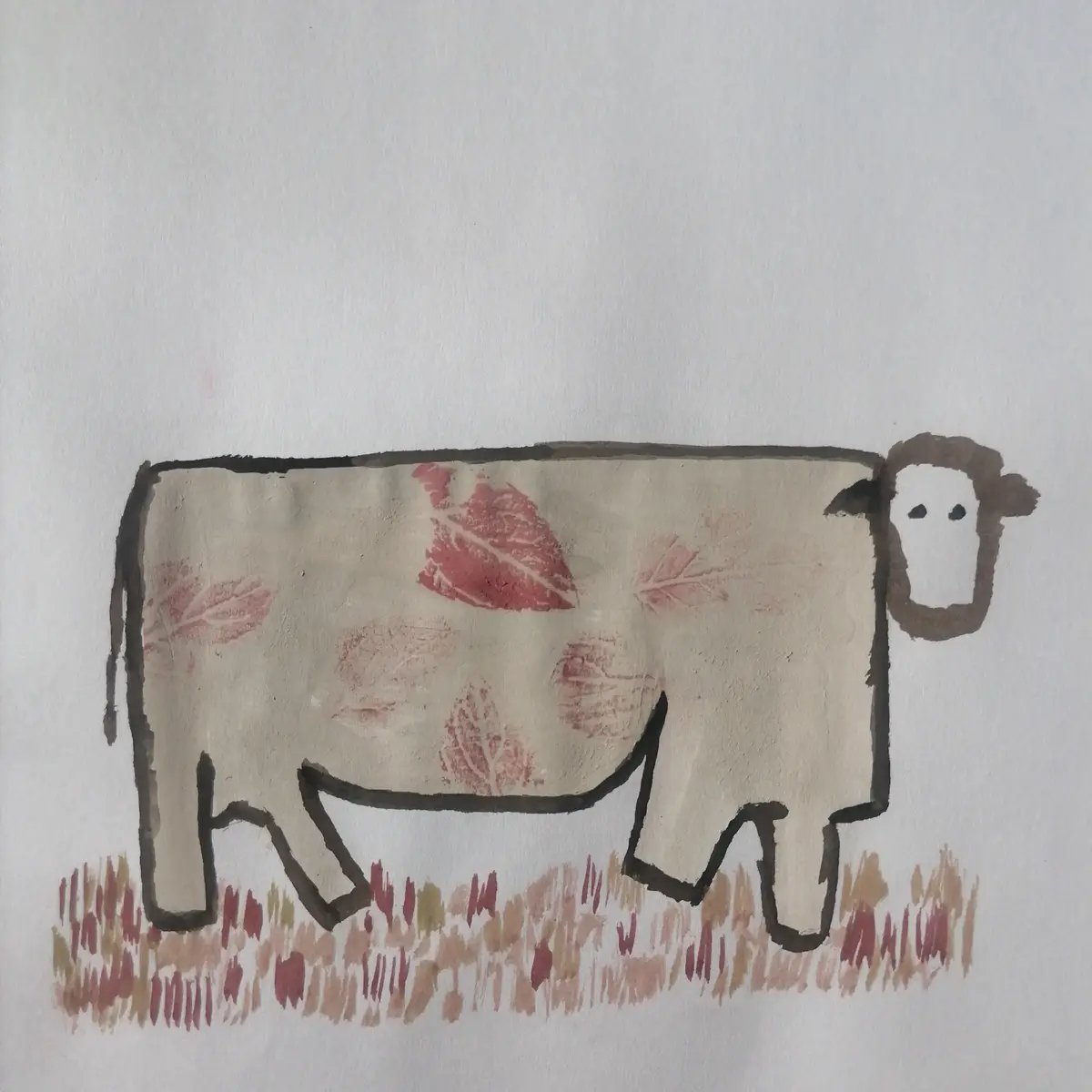 A simple, childlike drawing of a sheep-like animal with a beige body, brown head and legs, and red leaf-shaped markings on…
