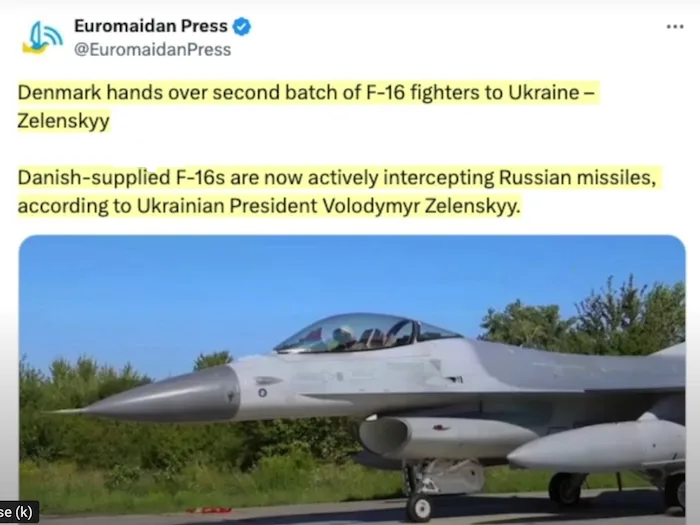 A screenshot of a tweet from 'Euromaidan Press' showing a grey F-16 fighter jet parked on a tarmac with trees in the…