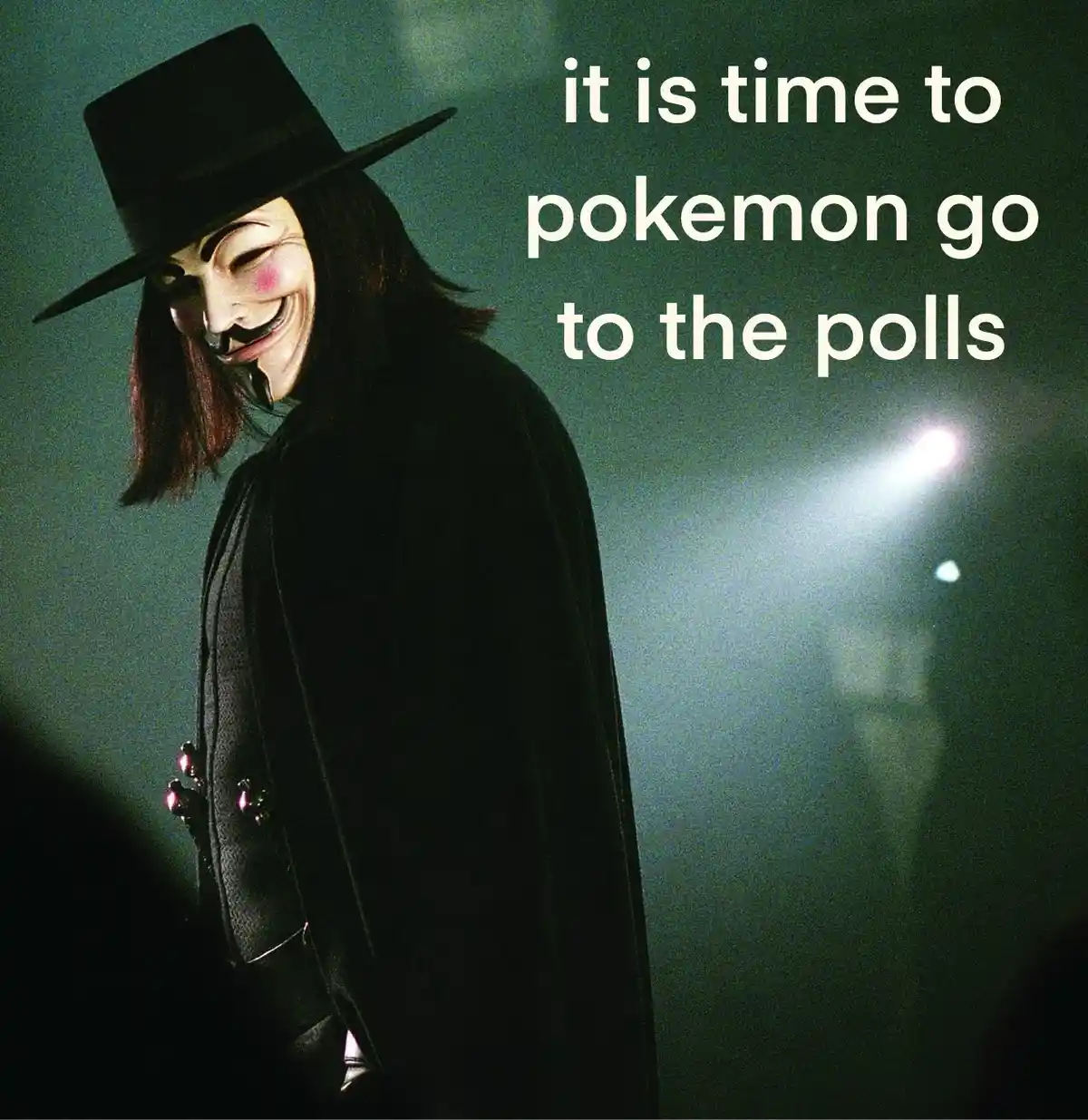 A person wearing a Guy Fawkes mask and a black top hat, dressed in a dark coat, stands in a dimly lit, smoky environment…