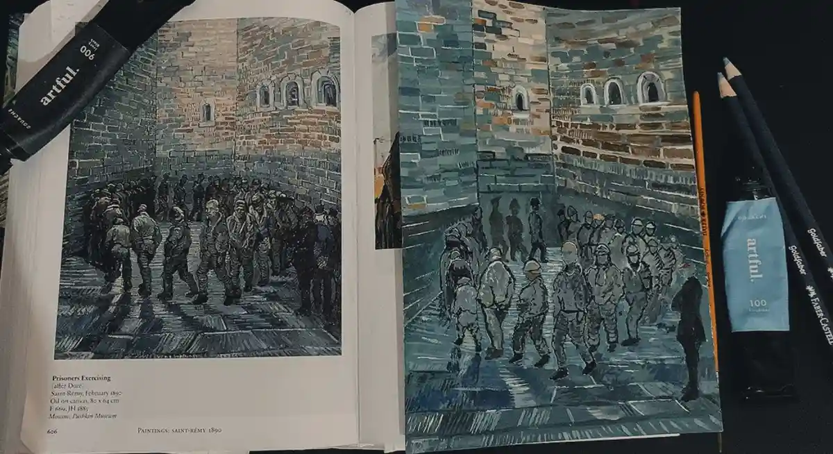 An open art book displays Vincent van Gogh's 1890 painting 'Prisoners Exercising' on the left page, with a detailed pencil…