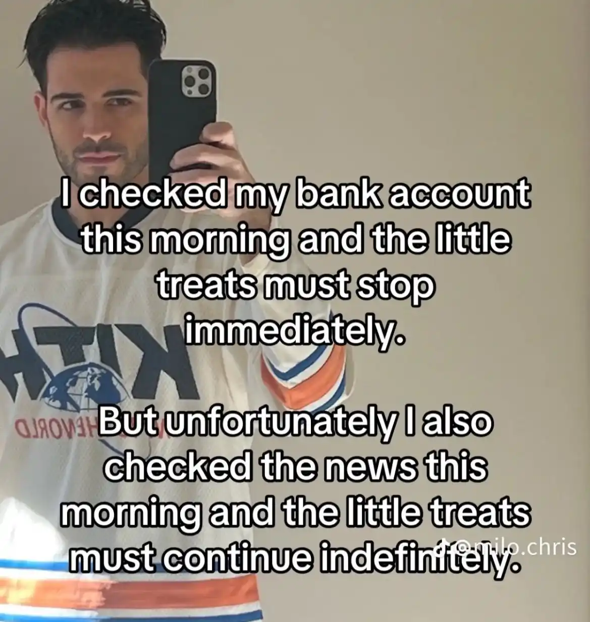 A man in a white hockey jersey takes a mirror selfie holding a black smartphone. Overlaid text reads: 'I checked my bank…