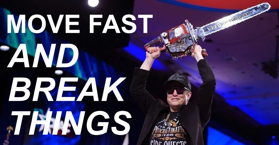 A man in a black jacket, cap, and sunglasses triumphantly holds up a chainsaw with 'VAPORWARE' written on the blade, against…