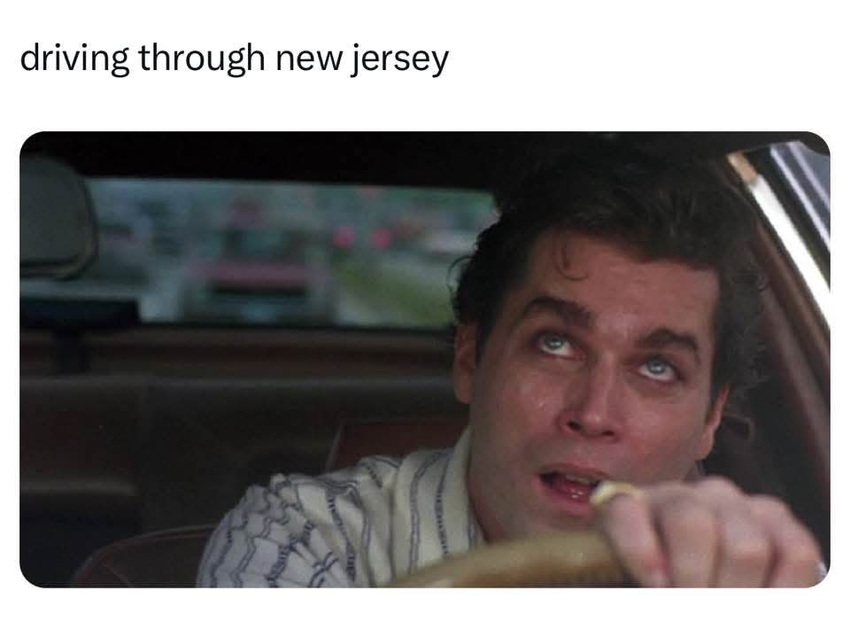 A man with wide, startled eyes is shown inside a car, gripping the steering wheel, with the text 'driving through new…