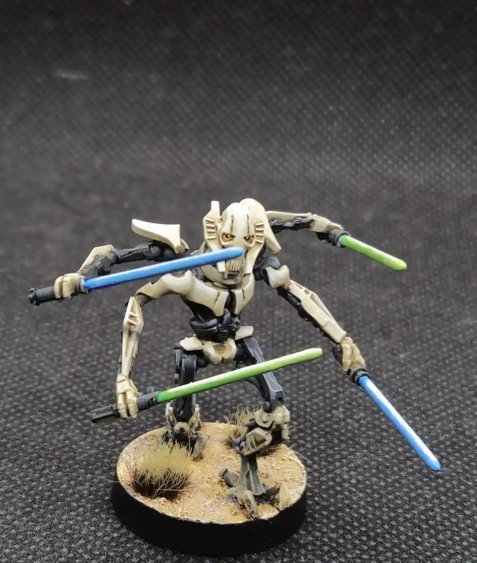 A painted Star Wars action figure of a skeletal, beige-and-black armored droid-like character stands on a circular base with…