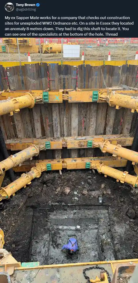 A high-angle photo shows a deep, muddy construction shaft with yellow support beams and a worker in a blue uniform and hard…