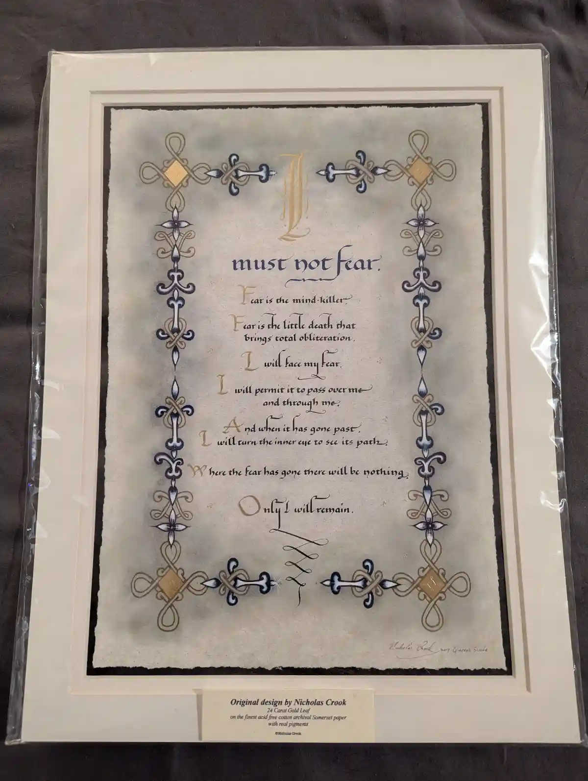A framed, ornate piece of calligraphy art featuring the 'I must not fear' mantra from the Dune universe, written in elegant…