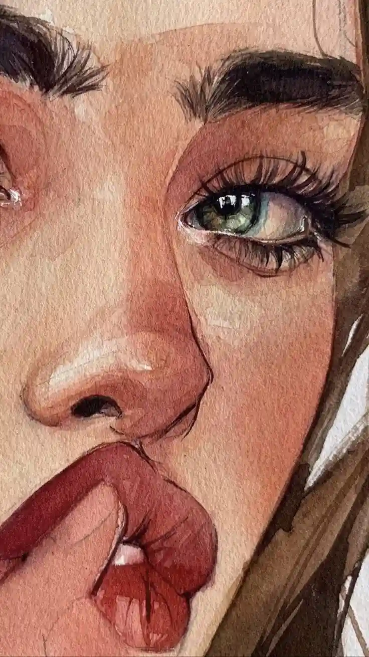 A watercolor painting shows a close-up of a person's face, focusing on their green eye, nose, and lips. The person's lips…