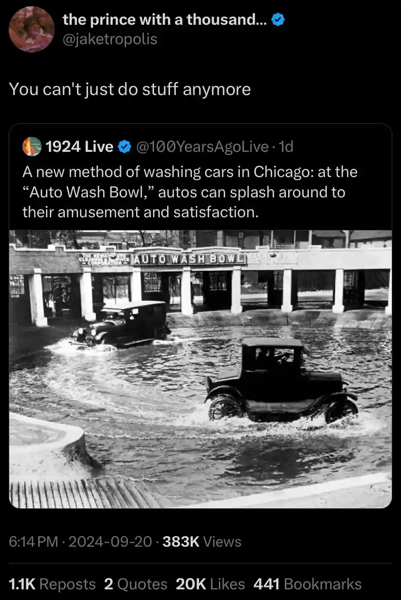 A black-and-white historical photo shows two vintage cars driving through a shallow, sloped water basin labeled 'AUTO WASH…
