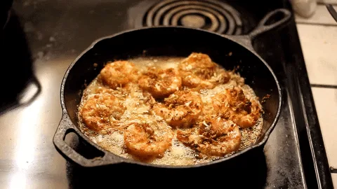Six identical images show shrimp sizzling in a cast-iron skillet on a stovetop, with no text or captions overlaid. The…