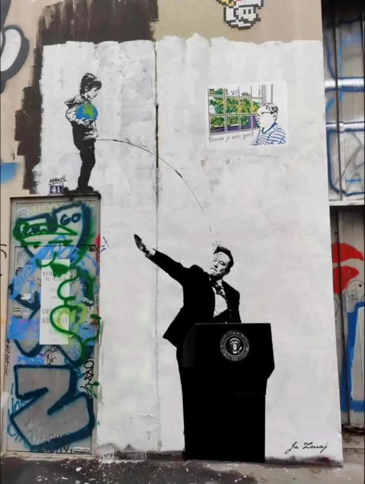 A street art mural shows a black-and-white silhouette of a man in a suit at a podium with the presidential seal, gesturing…