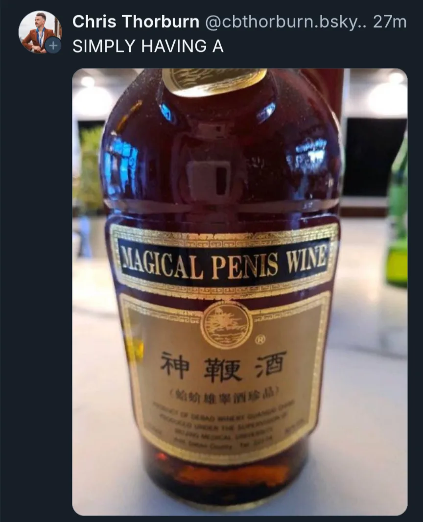 A close-up photo of a wine bottle with a gold and black label that reads 'MAGICAL PENIS WINE' in English and Chinese…