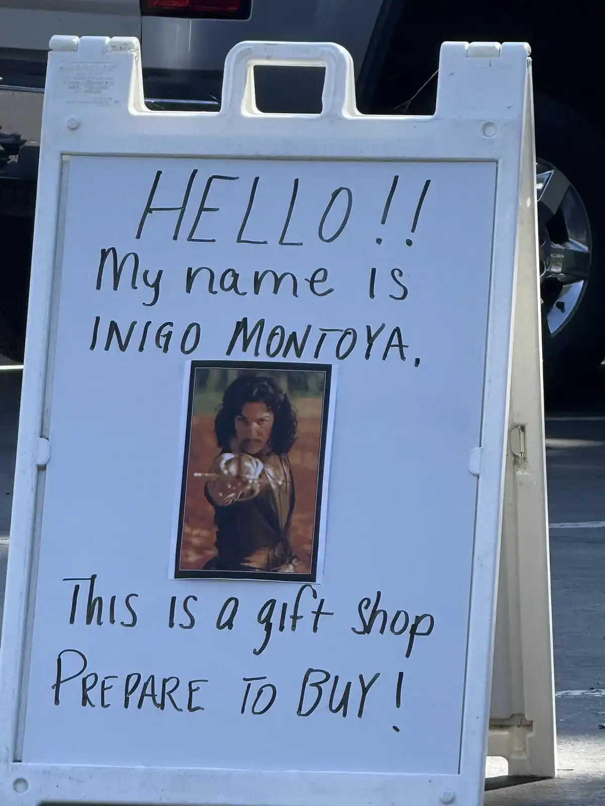 A white A-frame sign with handwritten text introduces 'INIGO MONTOYA' with a photo of the character from The Princess Bride…