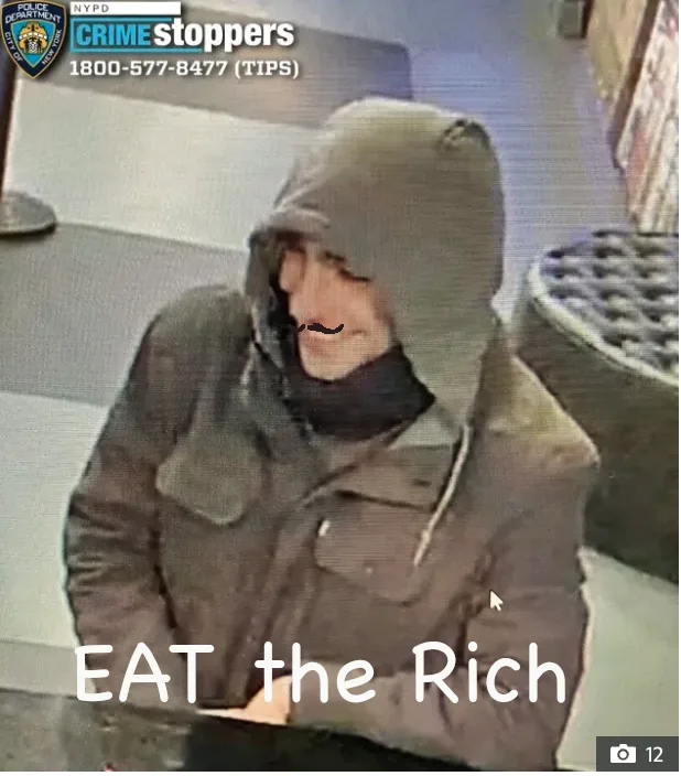 A grainy security camera image shows a person wearing a hooded jacket and scarf, with a crudely drawn mustache overlaid on…