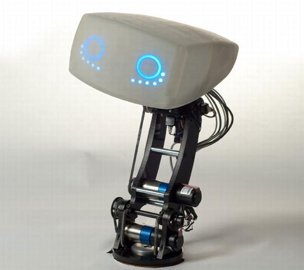 A robot with a gray, boxy head featuring glowing blue circular eyes and dots, mounted on a visible mechanical neck and torso…