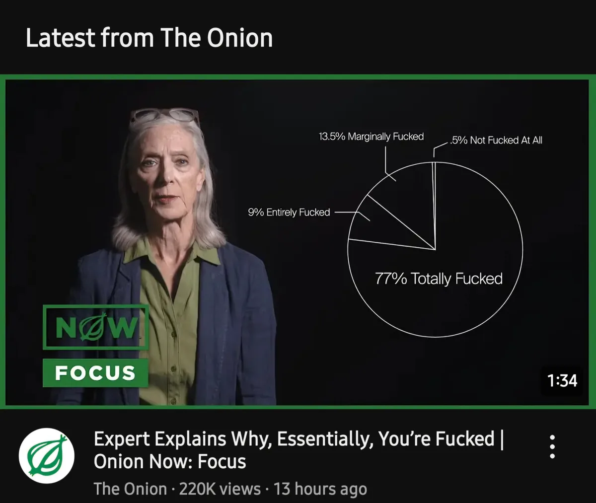 A screenshot of a YouTube video thumbnail from 'The Onion' showing a woman in a green shirt and blue blazer with glasses on…