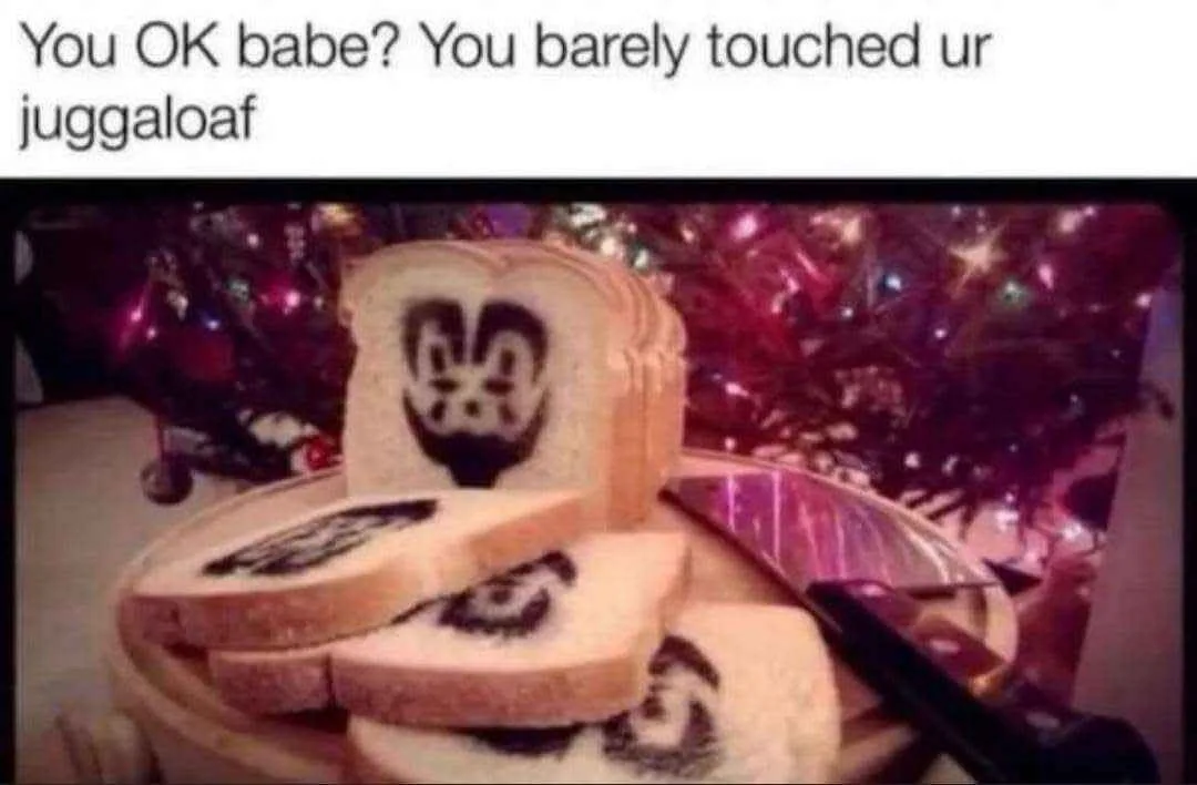 A stack of sliced white bread with a black, stylized face design on each slice, resembling a Juggalo logo, sits on a plate…