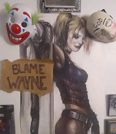 A wall displays a large Harley Quinn poster flanked by two masks: a clown mask on the left and a beige mask with 'GOD'…