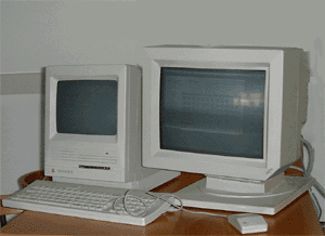 Two side-by-side photos of identical beige computer setups with CRT monitors, keyboards, and mice on a wooden desk. The left…