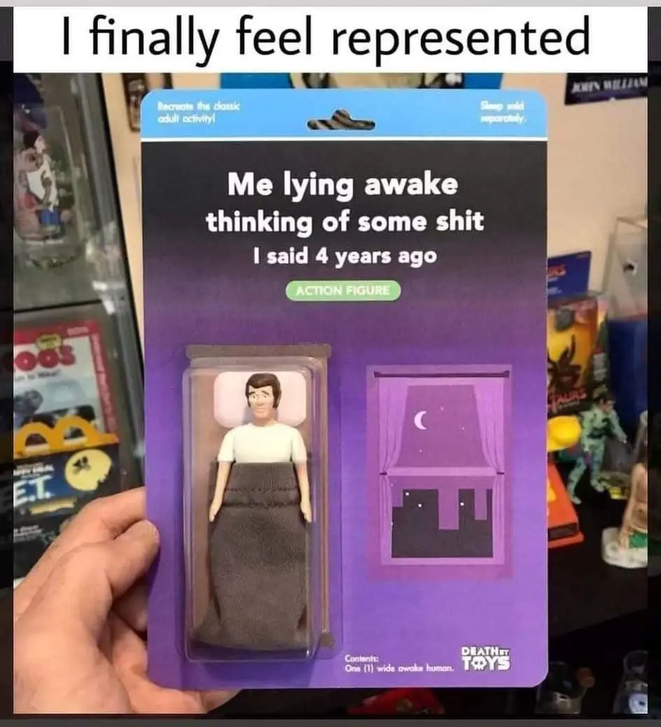 A hand holds a purple toy package labeled 'Recreate the classic adult activity!' featuring a plastic action figure of a man…
