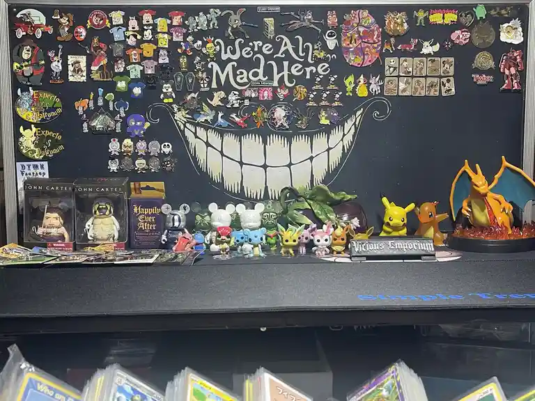 A black display board is covered with hundreds of colorful pins and collectible figures from franchises like Disney…