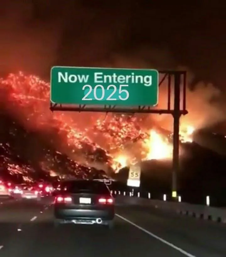 A nighttime highway scene shows a car driving under a green road sign that reads 'Now Entering 2025', with a massive…