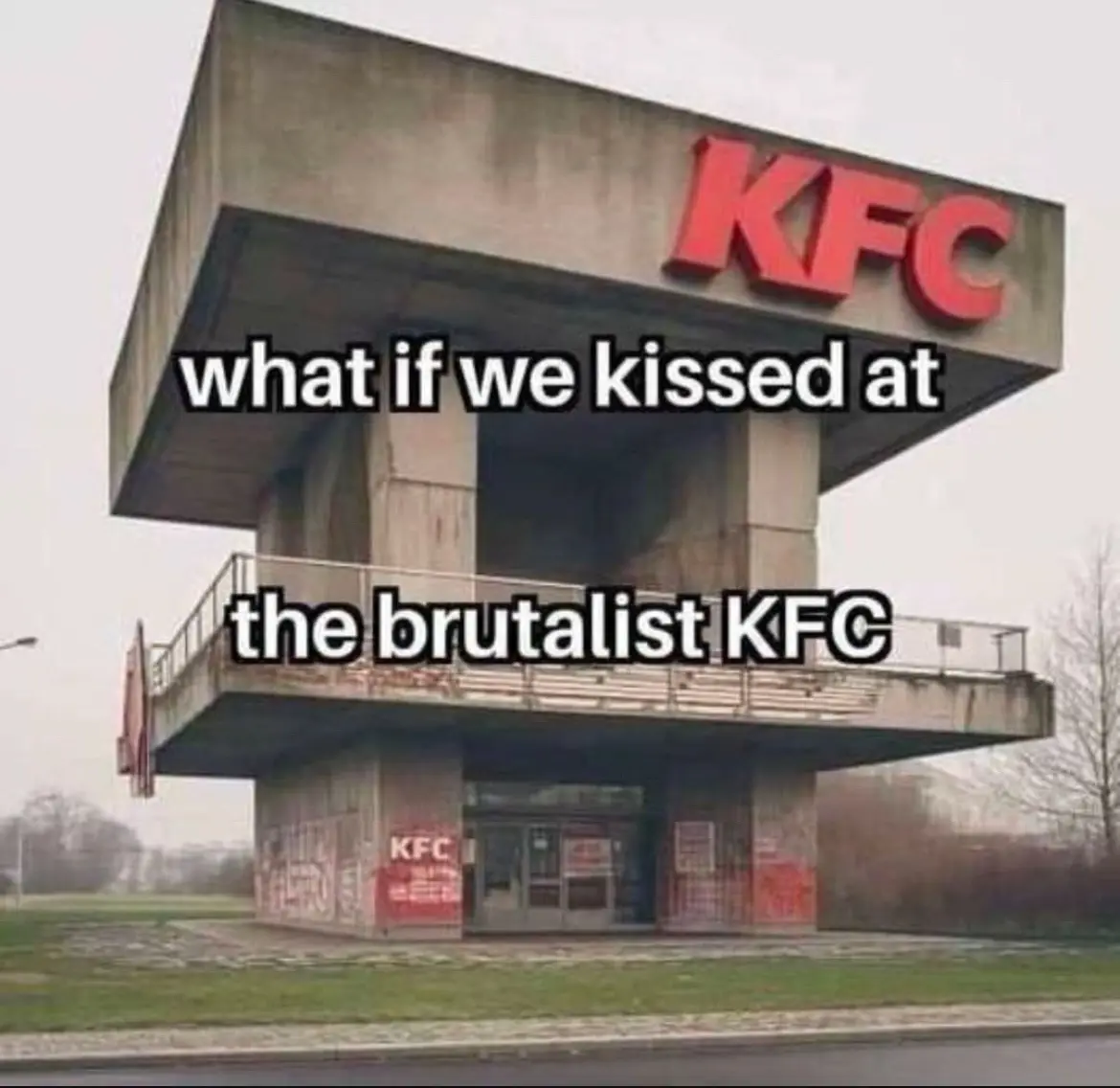 A photograph of a KFC restaurant with a stark, angular, concrete brutalist architectural style. The building has large red…