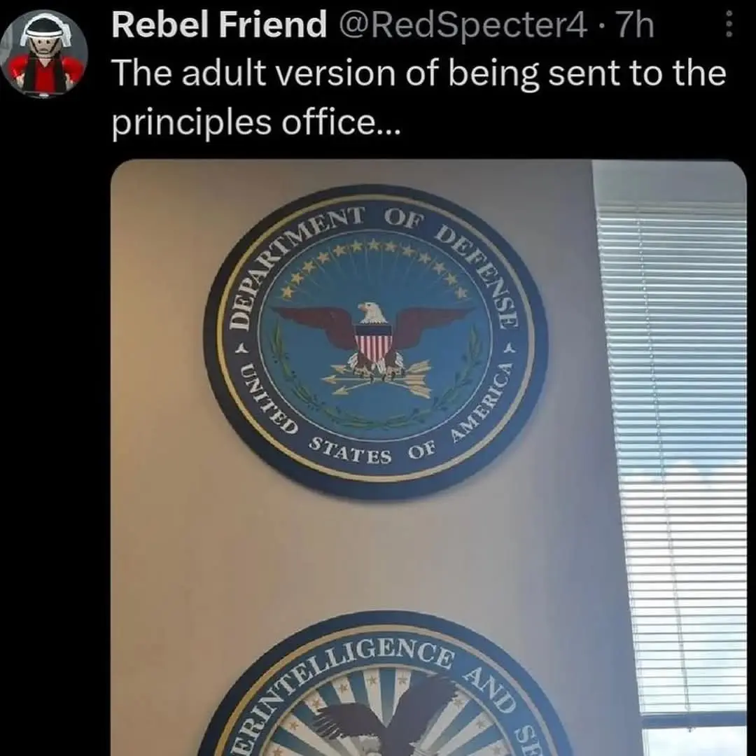 A photo shows two official-looking circular seals mounted on a beige wall, one above the other. The top seal clearly reads…