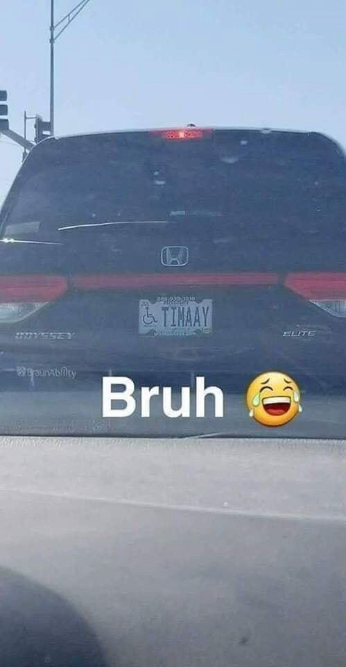 The image shows the rear of a dark-colored Honda Odyssey minivan with a vanity license plate reading 'TIMAAY' and a handicap…