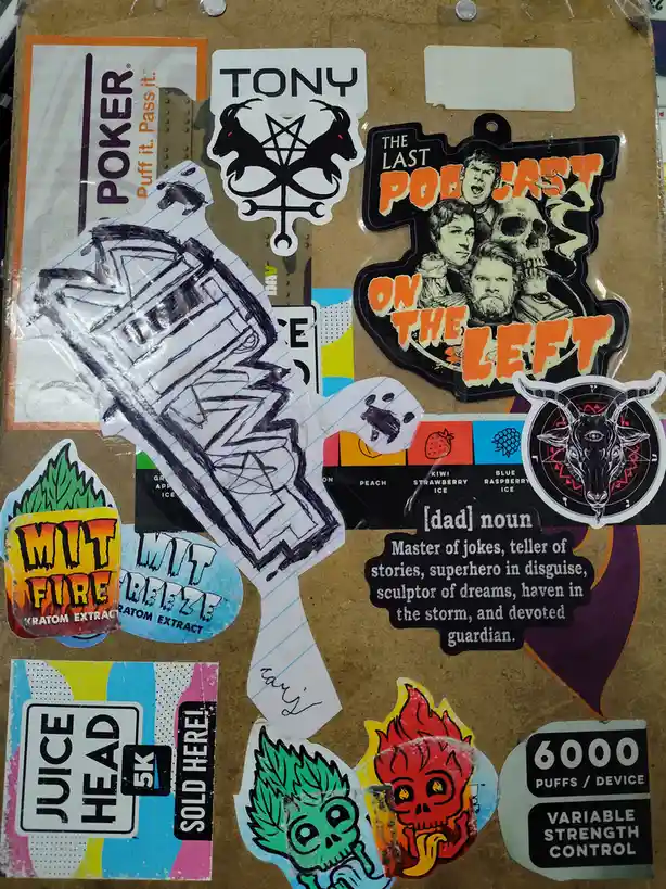 A collage of stickers on a cardboard surface, including 'POKER', 'TONY', 'THE LAST PODCAST ON THE LEFT', 'MIT FIRE', 'JUICE…