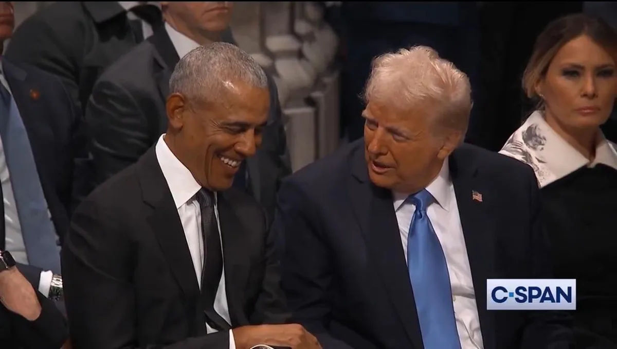 Barack Obama is visibly laughing while seated next to Donald Trump, who appears to be speaking to him. Melania Trump is…