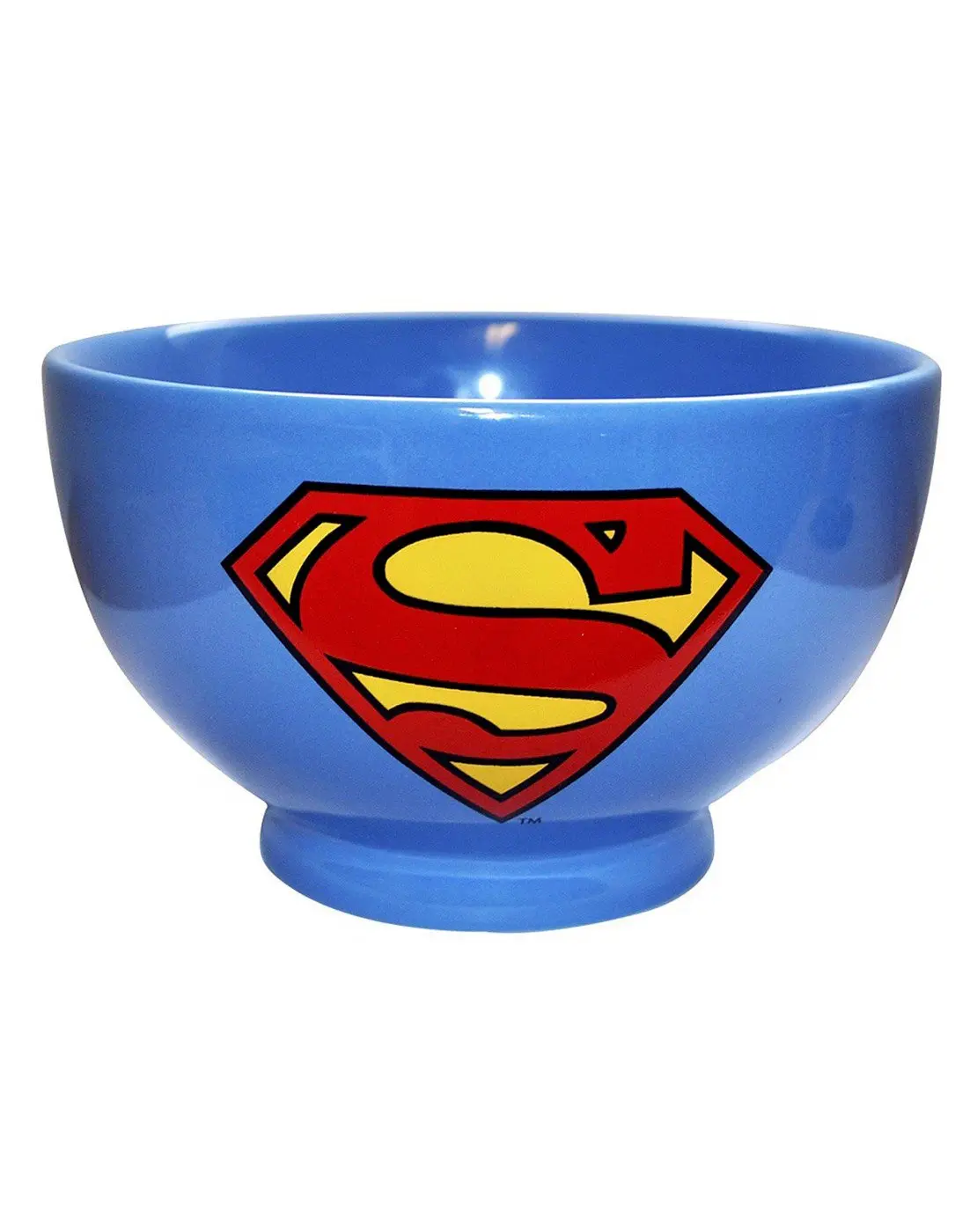 A glossy blue ceramic bowl features the iconic red and yellow Superman logo prominently on its side against a plain white…