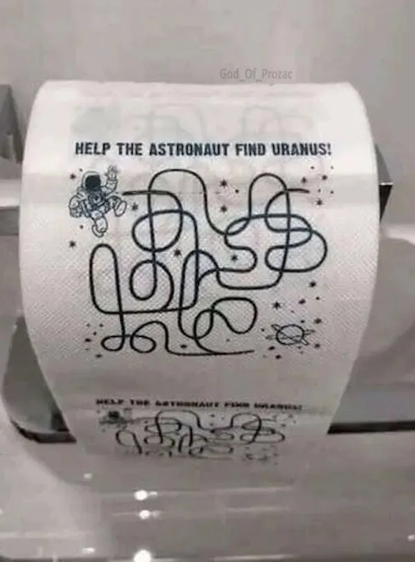A roll of toilet paper with a printed maze labeled 'HELP THE ASTRONAUT FIND URANUS!' featuring a cartoon astronaut at the…