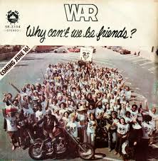 A vintage album cover for the band WAR, featuring a large group of people posing outdoors with a motorcycle in the…