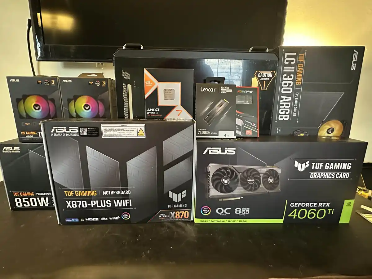 A collection of computer hardware boxes, including an ASUS TUF Gaming X870-Plus WiFi motherboard, an ASUS TUF Gaming GeForce…