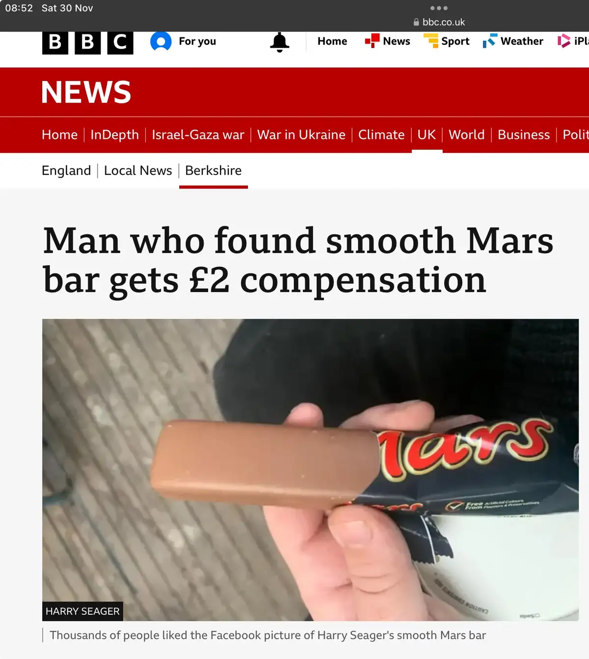 A screenshot of a BBC News article shows a hand holding a Mars bar with its wrapper partially peeled back, revealing a…