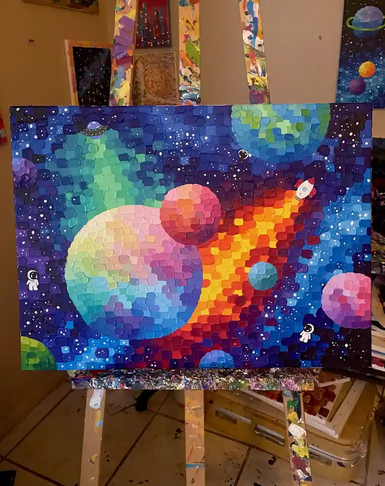 A colorful, textured painting of a space scene with planets, stars, a rocket, and small astronaut figures, displayed on an…