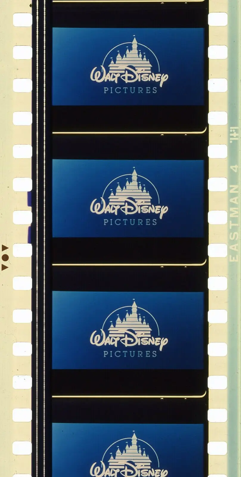 A close-up of a film strip showing four identical frames, each displaying the classic Walt Disney Pictures logo against a…