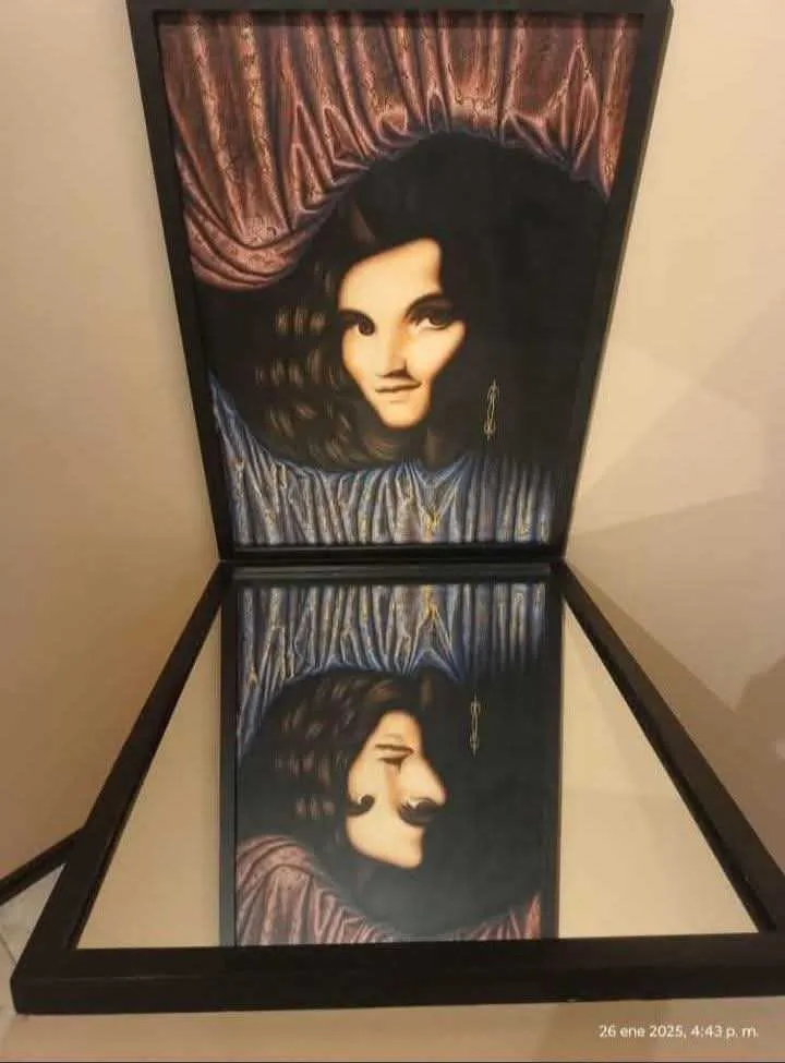 A framed painting is displayed open like a book, revealing two contrasting portraits: the top half shows a woman with dark…