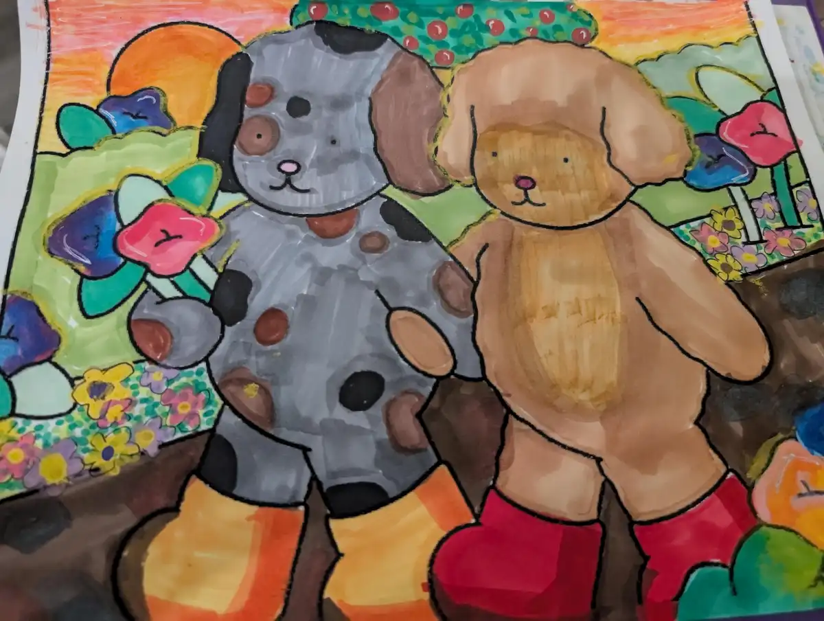 A colorful child's drawing shows two cartoon dogs standing side by side in a garden with flowers and a sunset. The dog on…