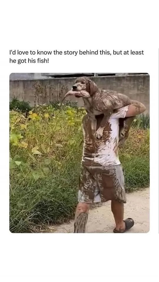 A person covered in mud carries a muddy dog on their shoulder; the dog has a fish in its mouth. The overlaid text reads…