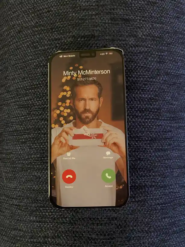 An iPhone screen displays an incoming call from 'Minty McMinterson' with a phone number, featuring a photo of Ryan Reynolds…
