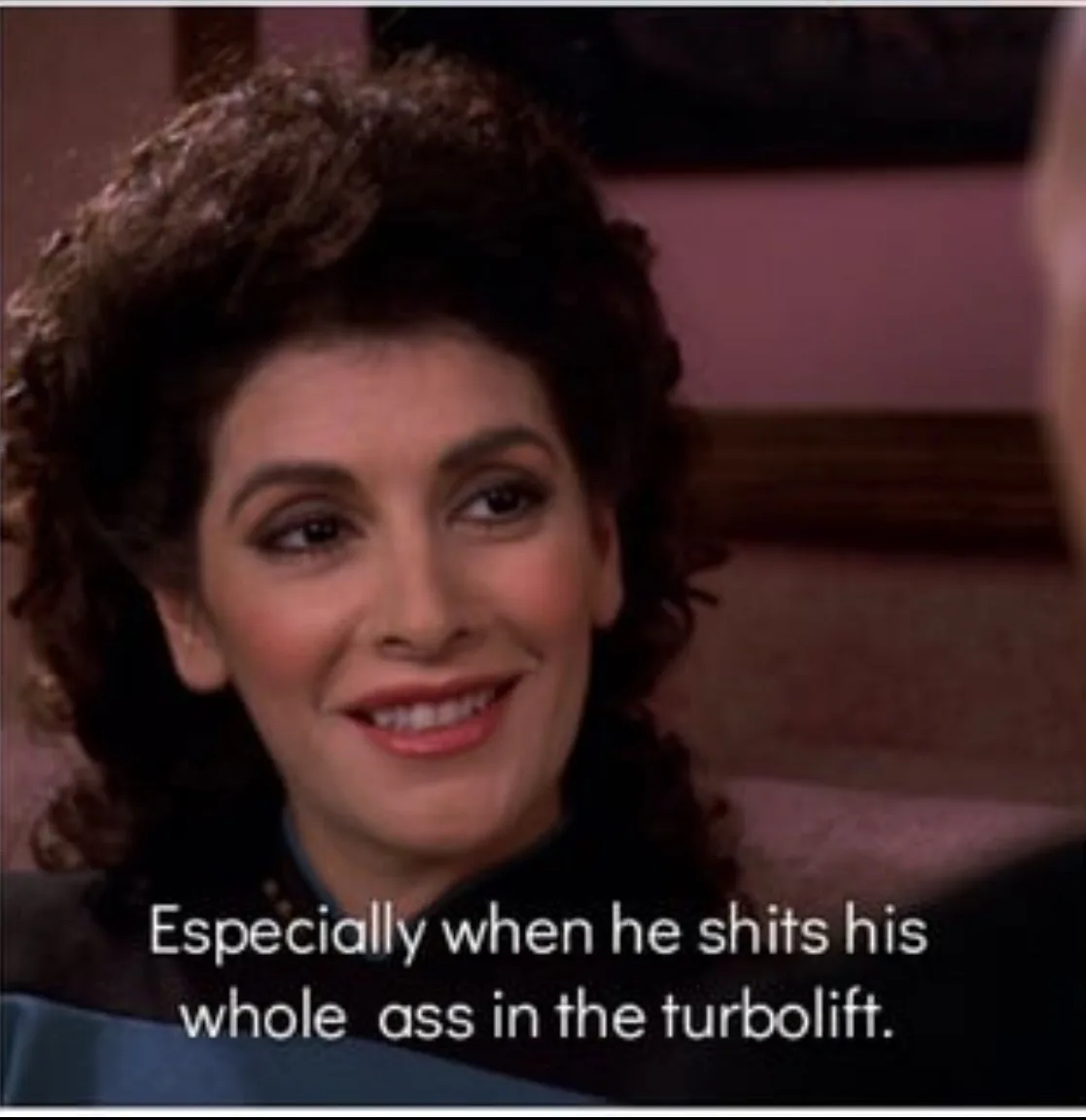 A close-up of a woman with dark curly hair smiling while wearing a Starfleet uniform. The overlaid text reads 'Especially…