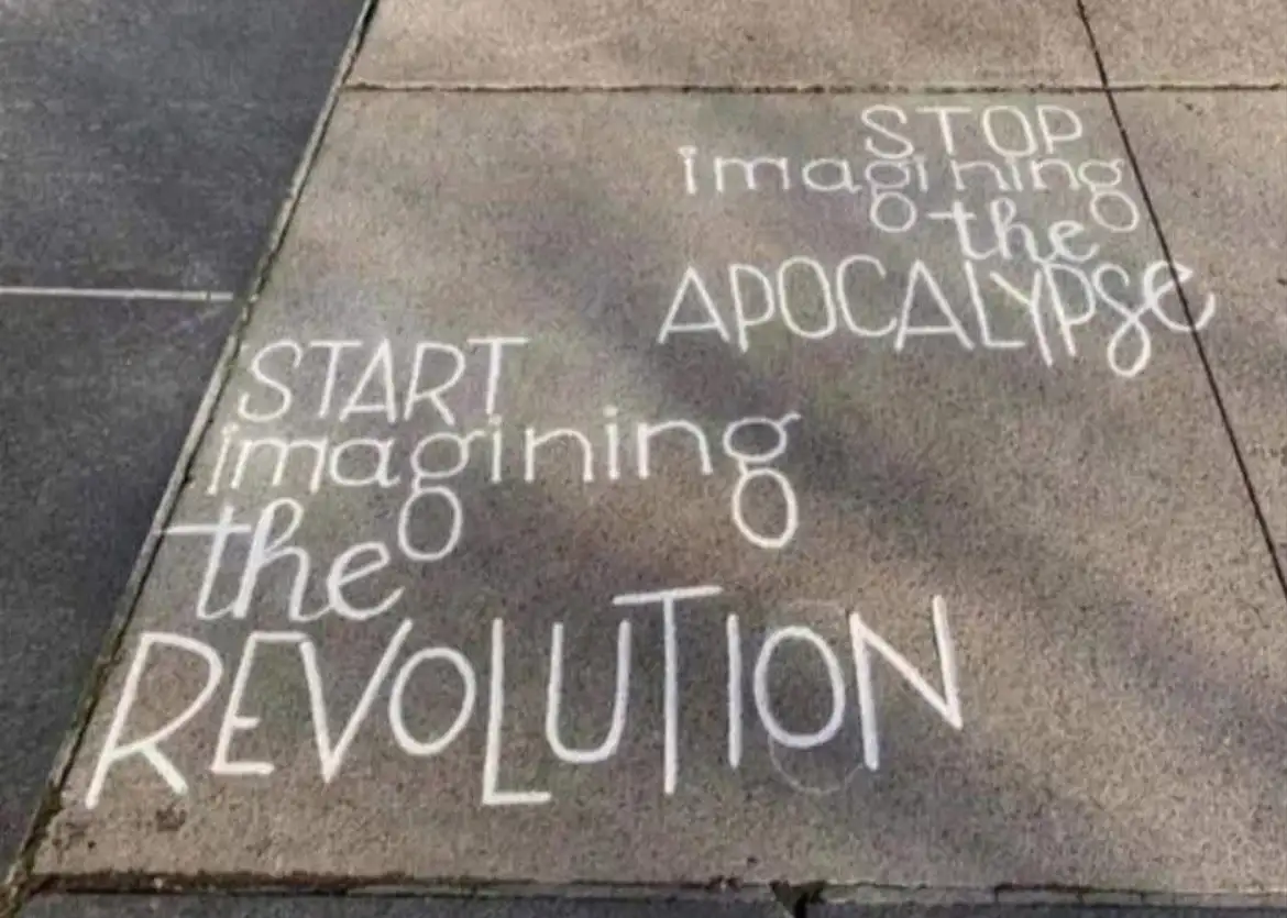 White chalk writing on a gray sidewalk pavement reads 'STOP imagining the APOCALYPSE' above 'START imagining the…