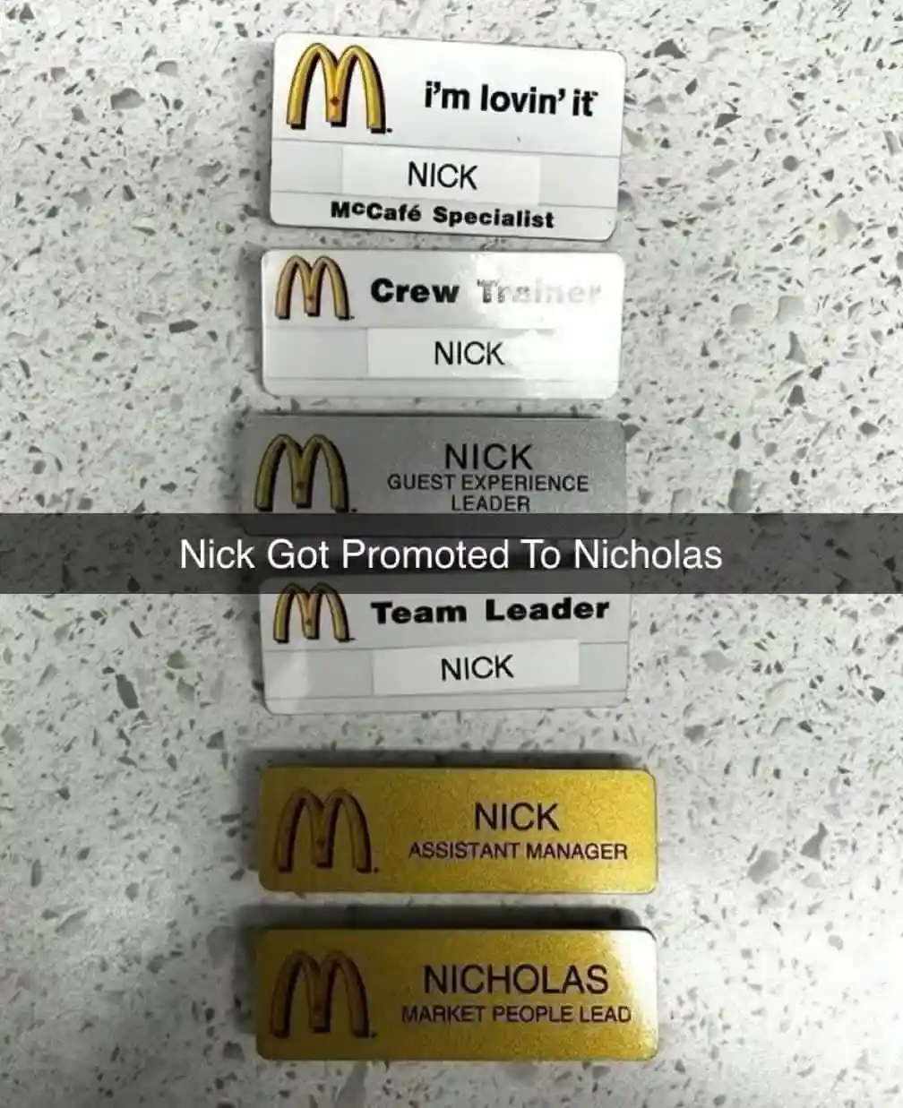 Six McDonald's employee name badges are arranged vertically on a speckled countertop, showing a progression from 'McCafé…