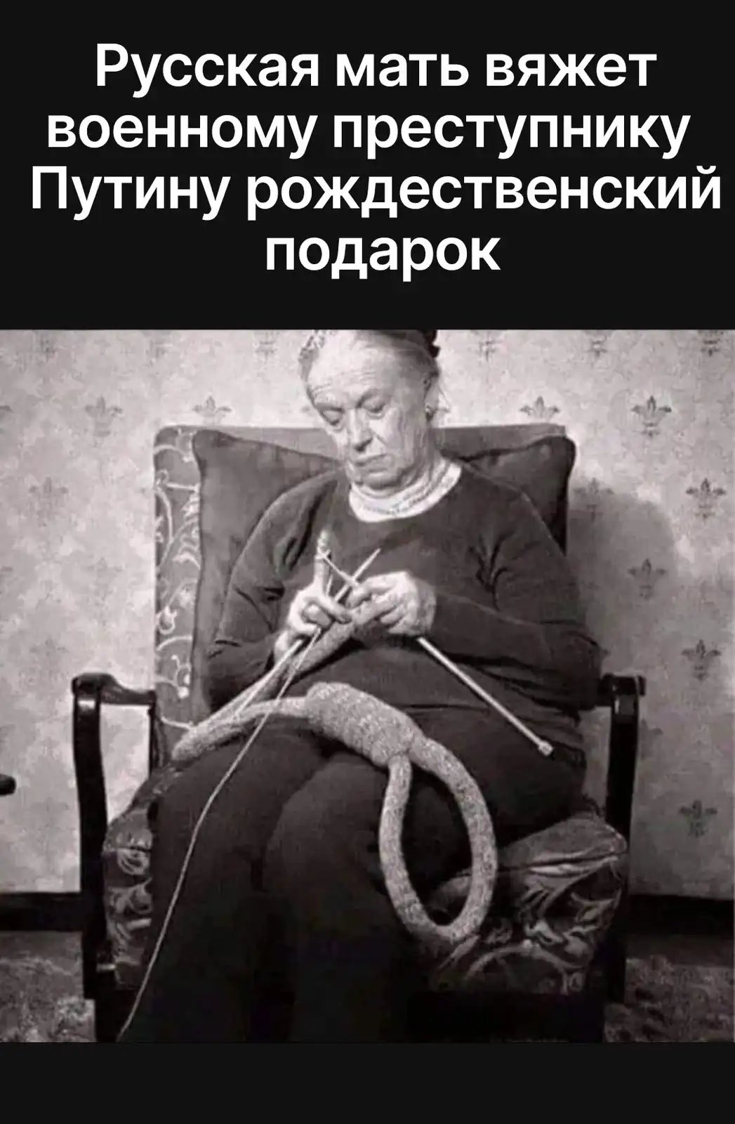 A black-and-white photo shows an elderly woman knitting in a chair, with a large, unfinished knitted loop resting on her…