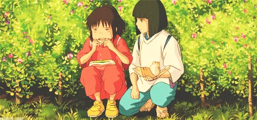 Two anime girls sit in a grassy field with pink flowers, the girl in red covers her face in distress while the girl in white…