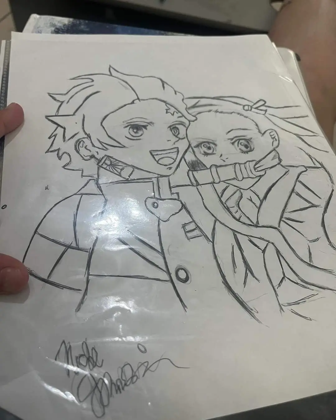 A hand-drawn pencil sketch of two anime characters, one with spiky hair and a wide smile, the other with long hair and a…