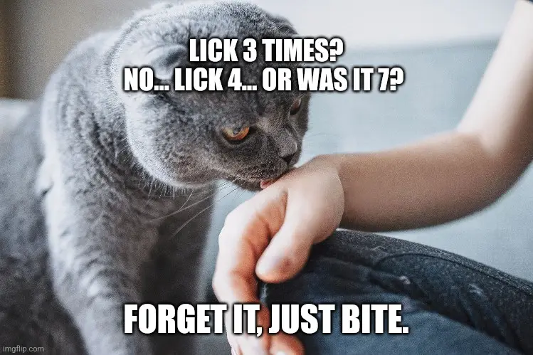 A gray cat is seen licking a person's hand. The image has white text overlaid in two parts: the top reads 'LICK 3 TIMES?…