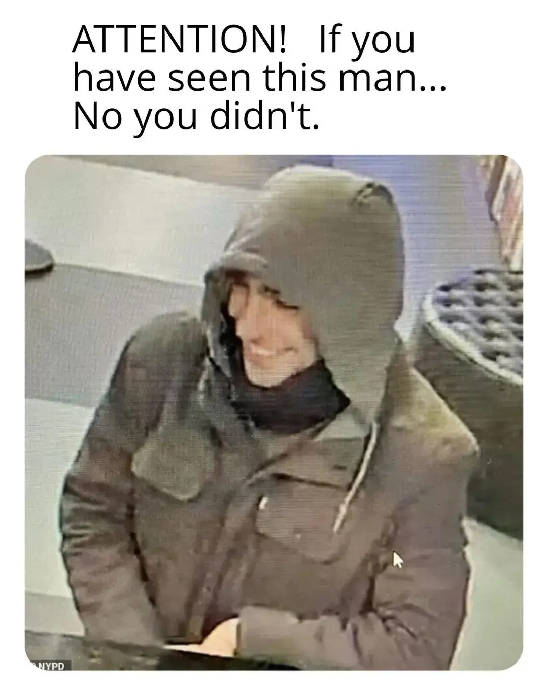 A grainy security camera image shows a person in a dark hooded jacket and scarf, smiling slightly while seated. The overlaid…